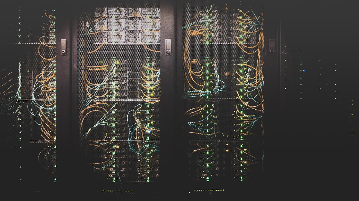 Illuminated data center corridor representing converged enterprise intelligence infrastructure